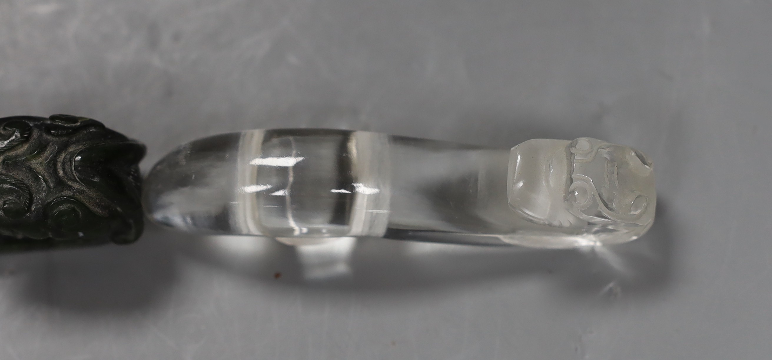 A Chinese rock crystal belt hook and a Chinese spinach green jade belt hook (2), largest 12cms long